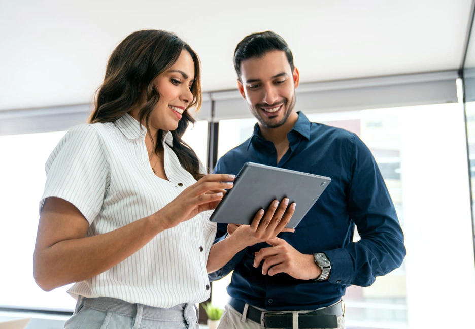 two young business people looking over a tablet