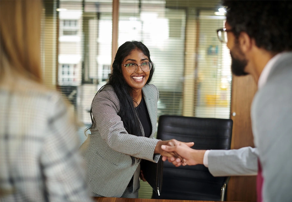 female employee shaking hands with male HR employee