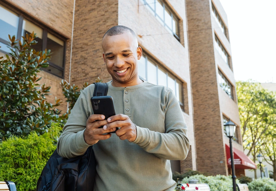 college student checking grades on smartphone