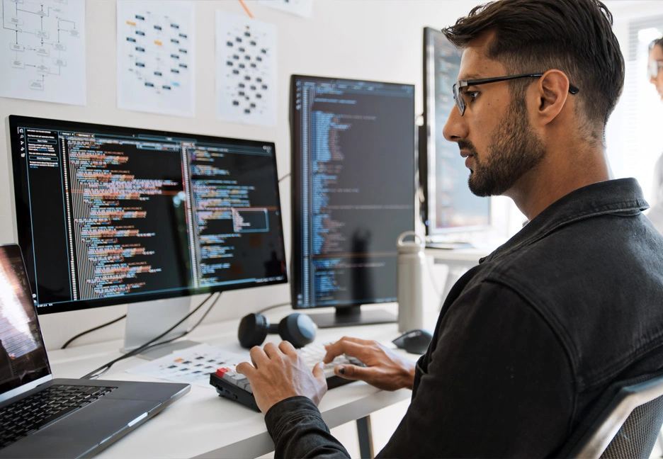 computer programmer coding at desk