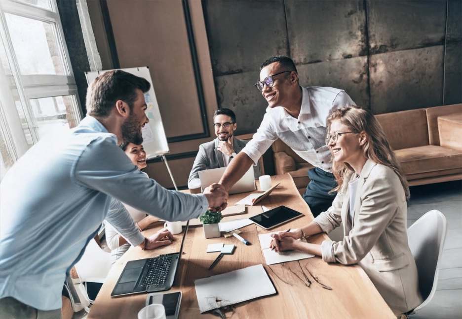 group meeting with two men shaking hands