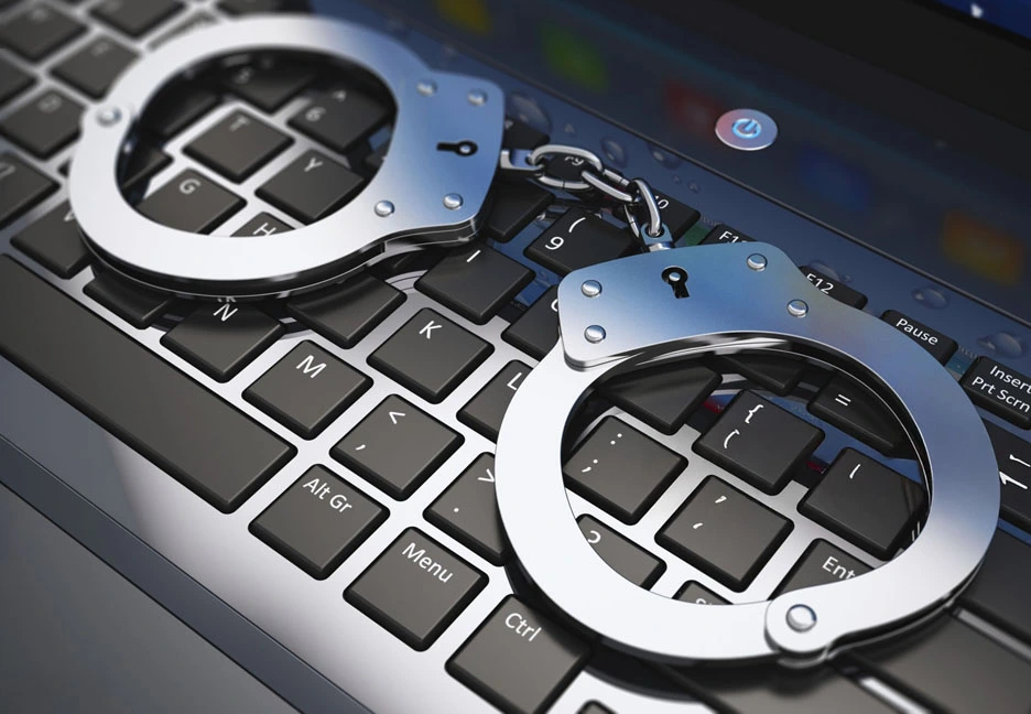 handcuffs on a laptop keyboard