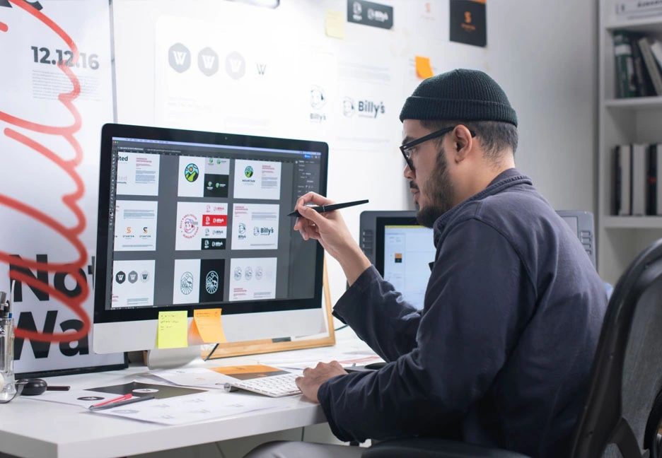 male graphic designer reviewing business card designs