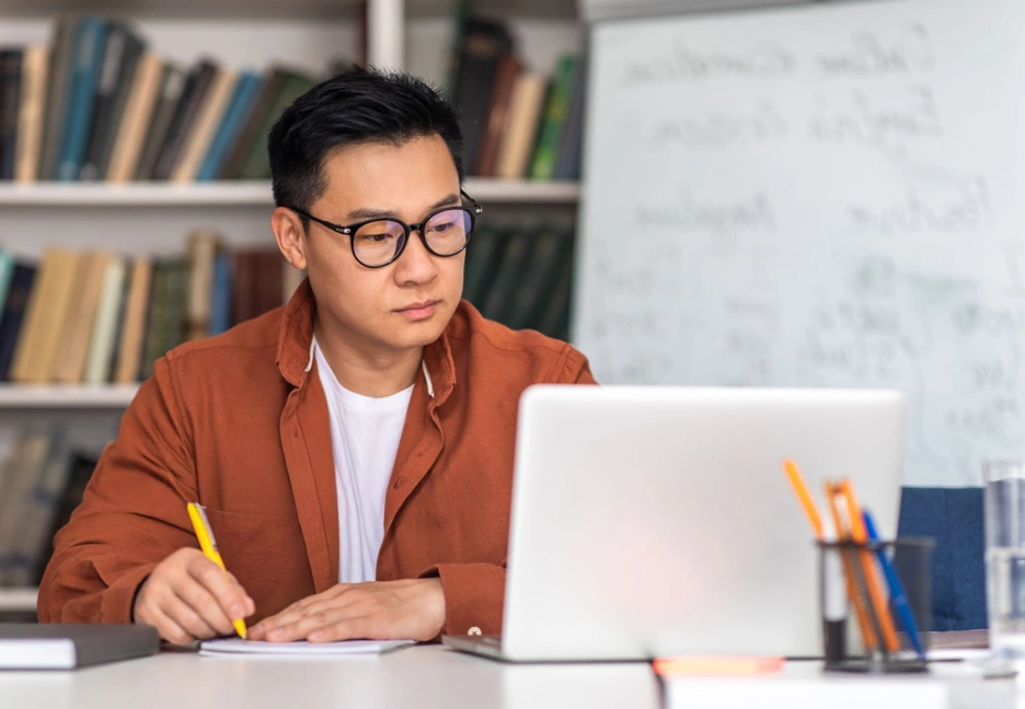 asian male on laptop