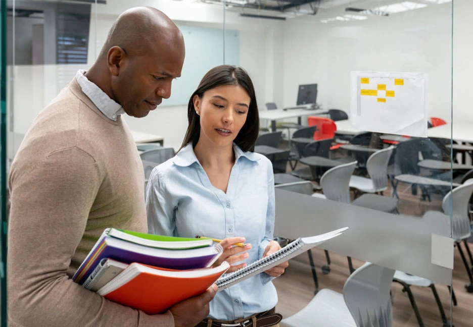 male teacher talking to female student