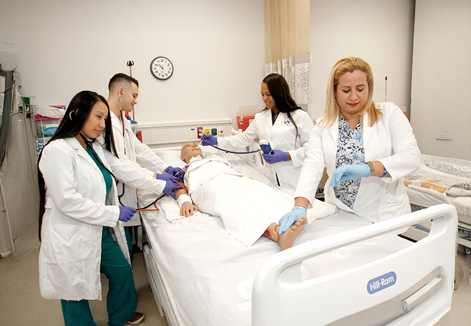 group of nursing students practicing on dummy
