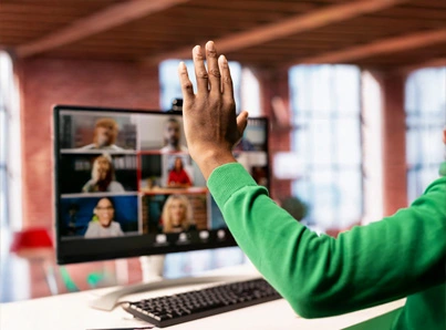 raising hand in front of video conference on computer