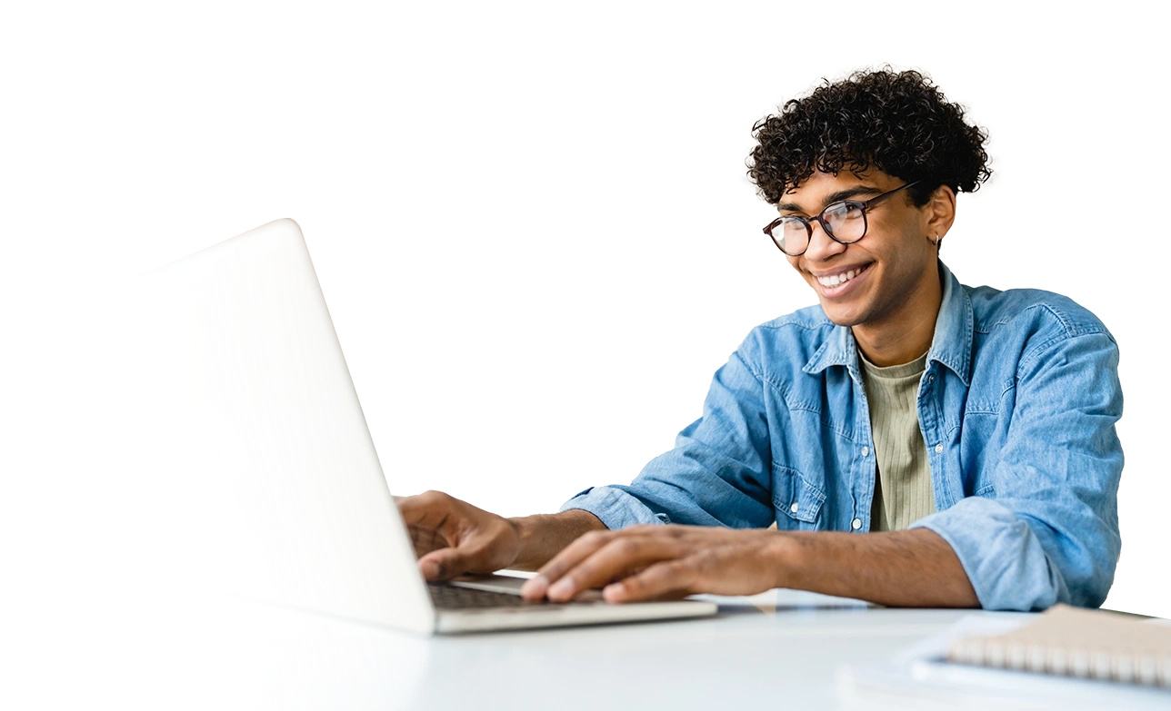 male student smiling while on laptop